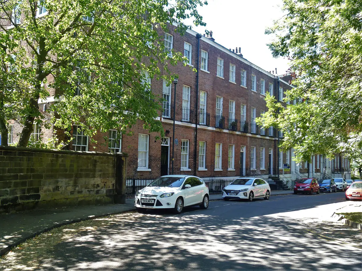 Georgian houses around St John's Square in Wakefield, under green trees